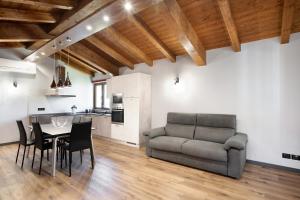 sala de estar con sofá, mesa y sillas en Agriturismo il Borgo - Ulivo en Villanova dʼAlbenga