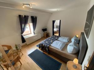 a bedroom with a bed and a table and a window at Ferienwohnung-Seeblick-Edersee in Waldeck