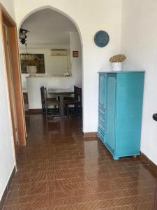 a dining room with a blue cabinet and a table at House for rent in Žrnovo