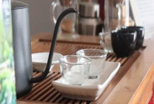 a coffee maker and two glasses on a counter at Trekker Camp in Chiang Mai