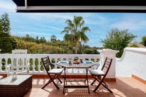 a patio with a table and chairs on a balcony at Las Palmas 2a Oasis Properties in Nerja