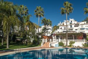 a large swimming pool in front of a white building at Las Palmas 2a Oasis Properties in Nerja