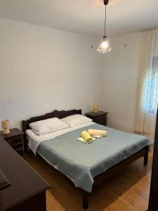 a bedroom with a bed with two pillows on it at Olive Island Apartments & Resort, 3 Stars Family Friendly in Neviđane