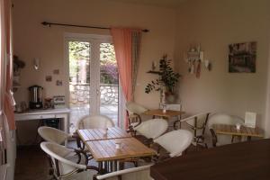 a dining room with tables and chairs and a patio at Penzion Ostravanka in Hranice