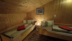 a room with two beds in a log cabin at Sonnenglück Chalet WILD272 in Wildschönau