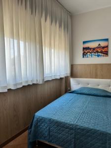 a bedroom with a bed and a window with curtains at Oasi Santa Rosa in Rome