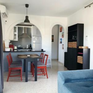 a kitchen with a table and chairs in a room at Las Palmas 15C Oasis Properties in Nerja