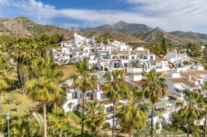 an aerial view of a large white house with palm trees at Las Palmas 15C Oasis Properties in Nerja