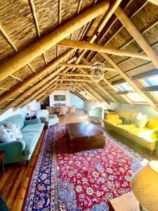 a living room with couches and a rug at The Burrow in Tulbagh +10 photos