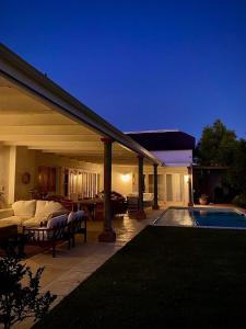 a house with a swimming pool next to a house at The Burrow in Tulbagh