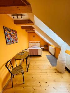 a bedroom with a bed and a table and chairs at Apartmán U SMRKU in Dvůr Králové nad Labem