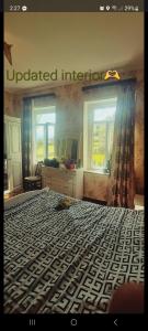 a bedroom with a large bed with aokedillusionillusion at Shorena's Homestay in Tsvirmi