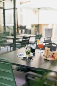 a table with a plate of food and drinks on it at Kyriad Metz Centre - Restaurant Moze in Metz