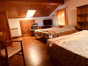a hotel room with two beds and a chair at PERLA Bianca DELLE 5 TERRE in La Spezia