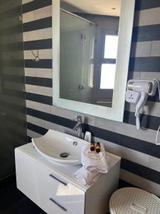 a bathroom with a sink and a mirror at Studio a Marina Casablanca in Casablanca