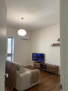 a living room with a couch and a flat screen tv at CASA VACANZE MAZARA in Mazara del Vallo