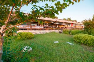 a building with a lawn in front of it at Ozlem Garden Hotel in Side