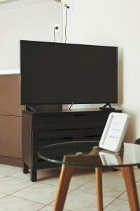 a flat screen tv sitting on top of a table at Plakoures Home in Kounoupidhianá