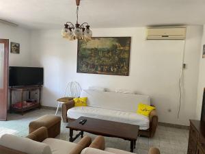 a living room with a white couch and a painting on the wall at House for rent in Žrnovo