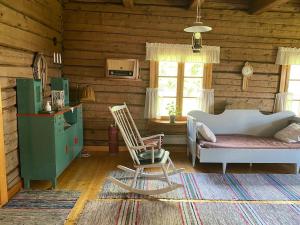 een kamer met een bed en twee stoelen in een hut bij Laattajan Pirtti vuokramökki 1-5 henkilölle in Hyrynsalmi