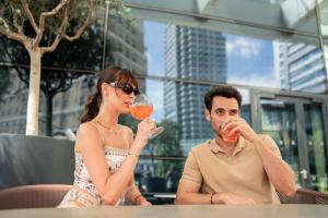 a man and woman sitting at a table drinking wine at Address Istanbul in Istanbul