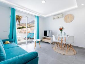 a living room with a blue couch and a table at 486 B Island Village Costa Adeje in Adeje