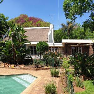 a house with a swimming pool in front of it at Boekenhout Accommodation in Pretoria