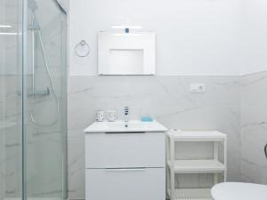 a white bathroom with a sink and a shower at 486 B Island Village Costa Adeje in Adeje +28 photos