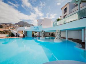 a large swimming pool in front of a building at 486 B Island Village Costa Adeje in Adeje