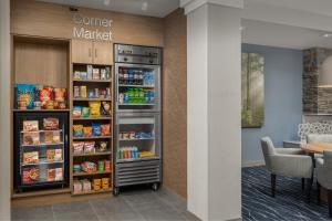 a refrigerator with food inside of it in a restaurant at Fairfield Inn & Suites Roanoke Hollins/I-81 in Roanoke