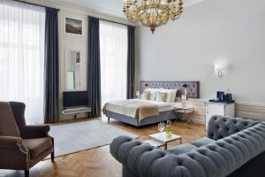 a living room with a bed and a couch at Wyndham Grand Krakow Old Town in Krakow
