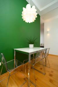 una mesa y sillas en una habitación con una pared verde en Apartment St.Jacob, en Dubrovnik