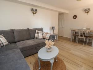 a living room with a couch and a table at Cock Bank Cottage in Wrexham