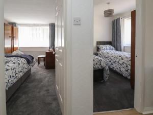 a hotel room with two beds and a mirror at Cock Bank Cottage in Wrexham