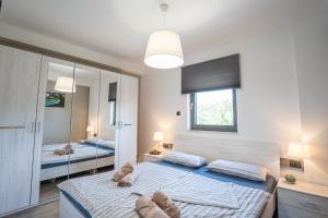 a bedroom with two beds and a mirror at Ulika in Kras +22 photos