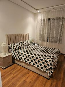 a large bed in a bedroom with a window at LUXURY 3 bedroom apartment with pool, Nouaceur, Morocco in Derroua