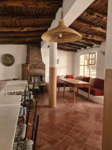a living room with a table and a couch at La Maison des Vagues in Sidi Kaouki