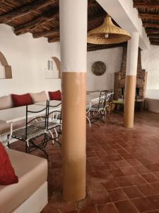 a dining room with tables and chairs in a building at La Maison des Vagues in Sidi Kaouki