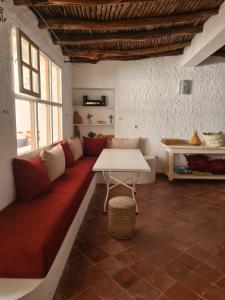 a living room with a couch and a table at La Maison des Vagues in Sidi Kaouki