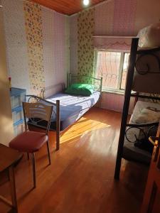 a bedroom with a bunk bed and a chair and a window at Men's Hostel in Fatih, Istanbul in Istanbul