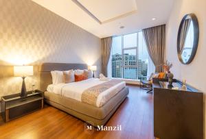 a hotel room with a bed and a large window at Manzil - Stylish 3BR in Palm w Private Beach & Sea View in Dubai
