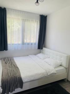 a bed in a bedroom with a window at Tiny House by the forest 1 