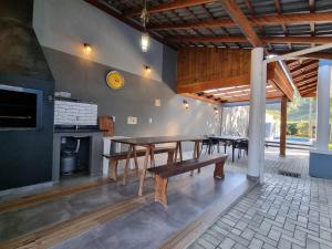 a dining room with a table and a fireplace at Parada Vale Europeu - Timbó SC in Timbó