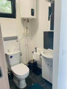 a bathroom with a toilet and a sink at Tiny House by the forest 1 