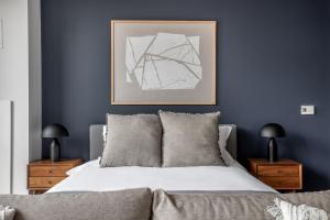 a bedroom with a bed with blue walls and a picture at Loop Studio w theater pool nr Millennium Park CHI-958 in Chicago +38 photos