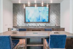 a conference room with a table and chairs and a large screen at Loop Studio w theater pool nr Millennium Park CHI-958 in Chicago