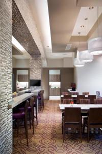 a restaurant with tables and chairs in a room at Residence Inn by Marriott West Palm Beach Downtown in West Palm Beach