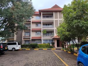 a building with a parking lot in front of it at Lantana Gardens B2 & B8 Apartment in Nairobi