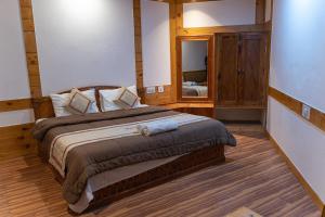 A bed or beds in a room at THE CONIFER