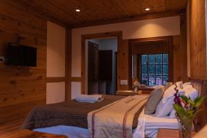 A bed or beds in a room at THE CONIFER